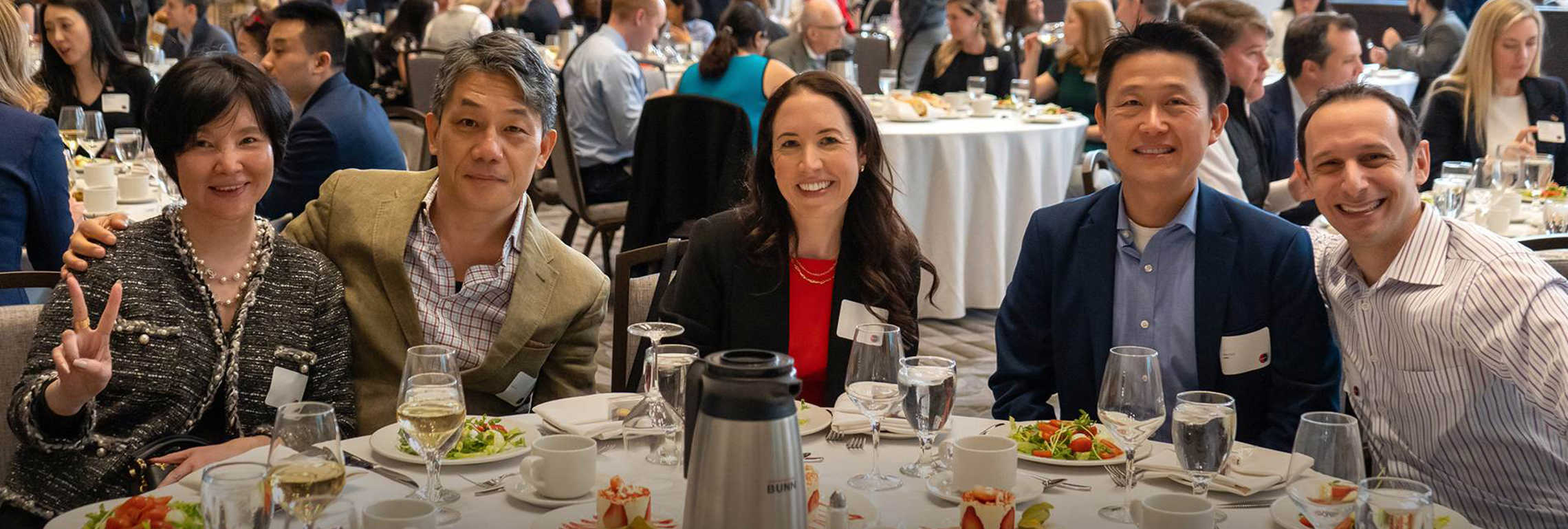 Five alumni sitting around a table at Global Ivey day.